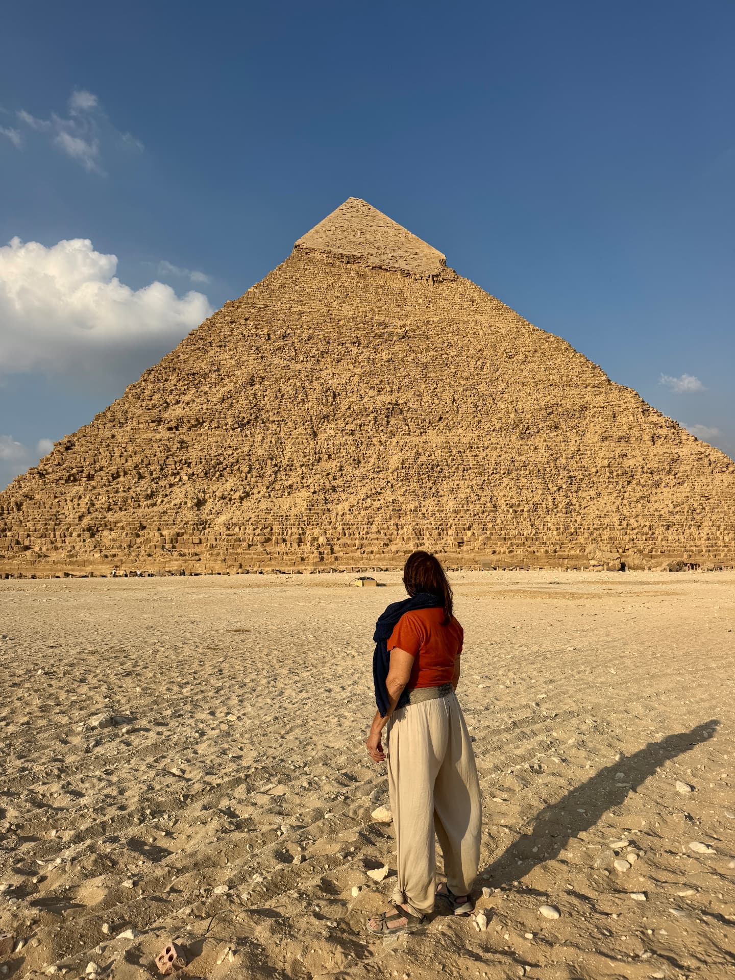 A woman standing before a pyramid at Giza